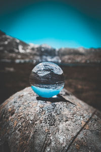 Close-up of rocks on rock against blue sky