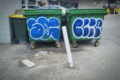 Garbage can against blue wall