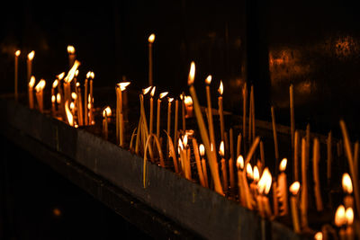 Illuminated candles in temple at night