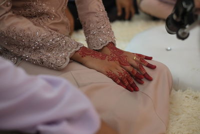 Midsection of woman with henna tattoo