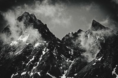 Low angle view of mountain range against sky