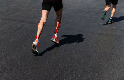 Low section of people running on road