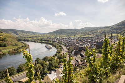 High angle view of river and cityscape against sky