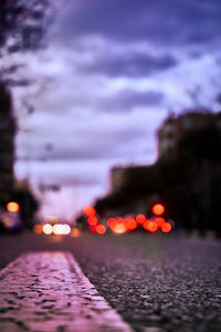 Defocused image of illuminated lights in city at night