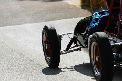 Close-up of person in racecar on sports track