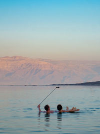 Scenic view of lake against sky during sunset