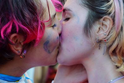 Close-up portrait of woman with multi colored hair