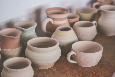 Many clay pots on the table in pottery