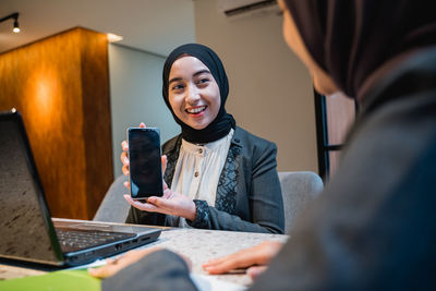 Young woman using mobile phone