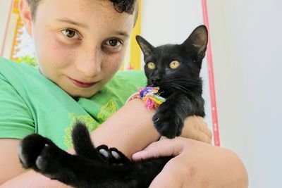 Portrait of woman holding cat