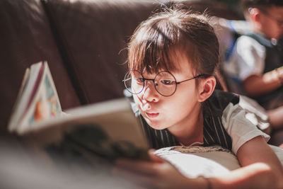 Portrait of boy looking at book