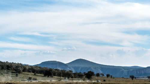 Scenic view of landscape and mountains against sky