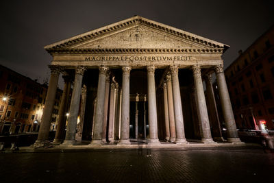 Low angle view of illuminated pantheon building against sky at night. 