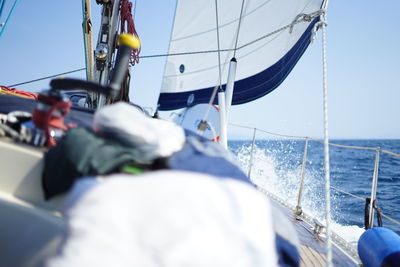 Rear view of sailboat sailing in sea against sky