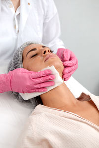 Midsection of doctor examining patient at clinic