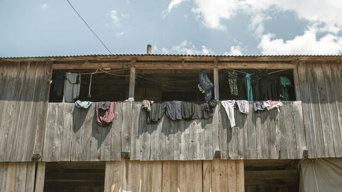 Low angle view of clothes drying on roof against building
