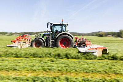 Tractor mowing grass