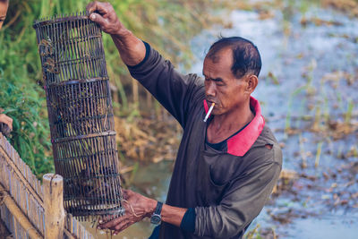 Farmer smoking while working on agricultural field