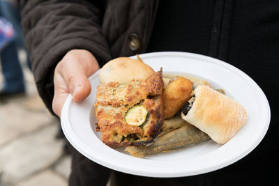 Midsection of man holding food