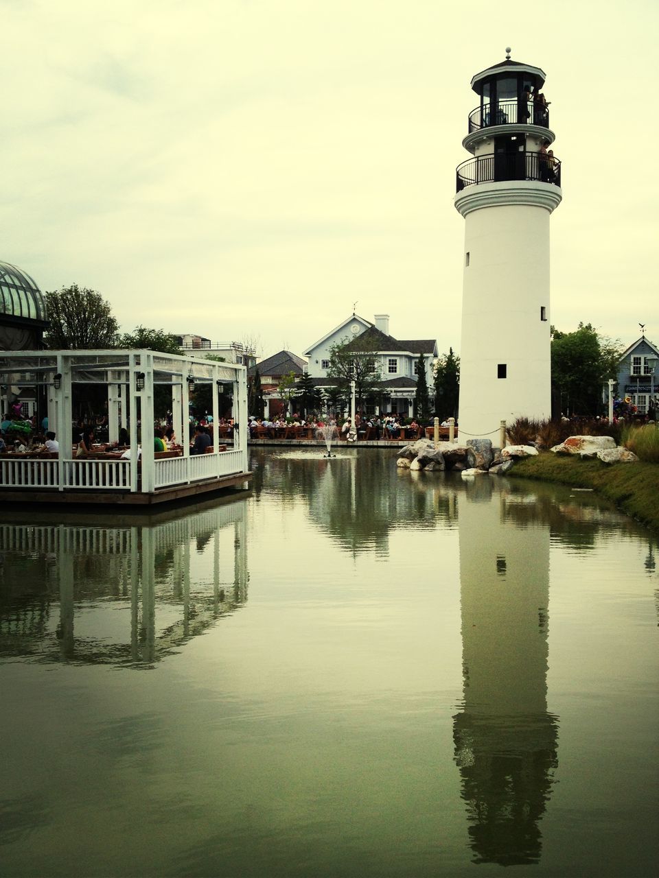 architecture, built structure, building exterior, water, waterfront, reflection, sky, river, tower, city, lighthouse, building, canal, cloud - sky, outdoors, day, cloud, lake, rippled, no people