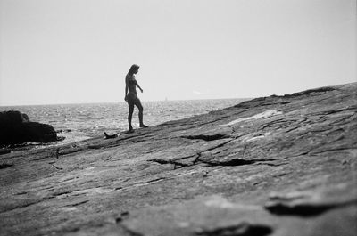 Rear view of man walking on rock