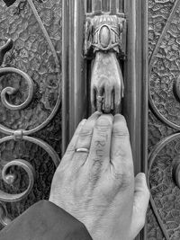 Close-up of hand holding door