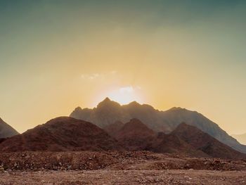 Scenic view of mountains against sky during sunset