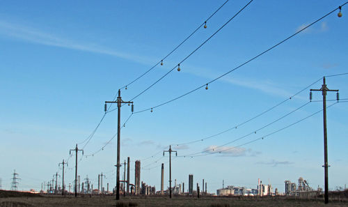 Low angle view of electricity pylon against sky