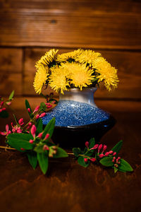 Close-up of yellow flowering plant on table