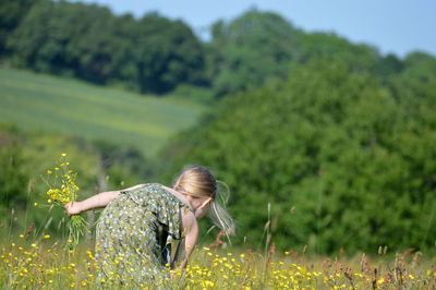 Woman with flower petals on field