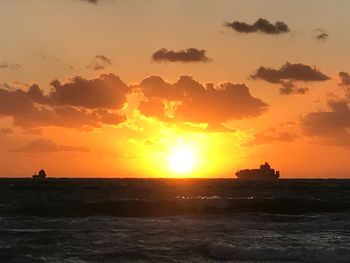 Scenic view of sea against orange sky