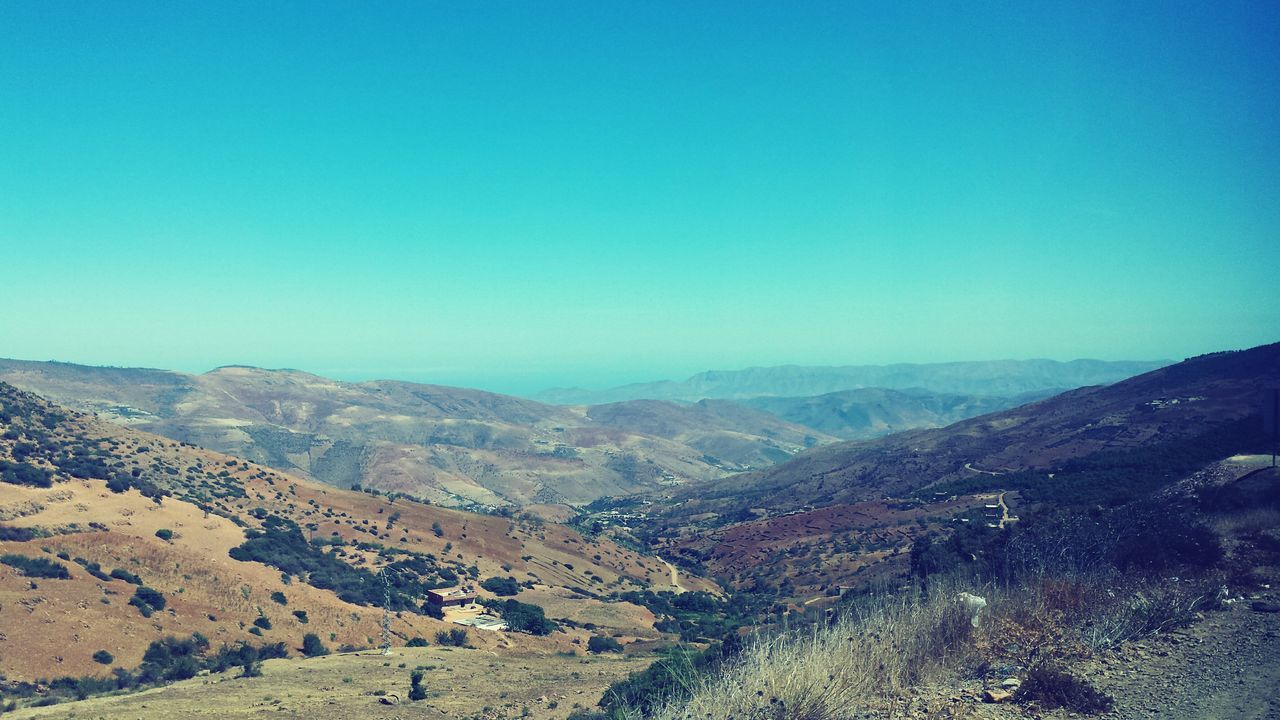 clear sky, mountain, tranquil scene, blue, tranquility, landscape, scenics, beauty in nature, nature, mountain range, non-urban scene, idyllic, remote, horizon over land, outdoors, day, no people, hill, physical geography, non urban scene, sky, travel destinations, majestic