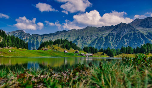 Scenic view of lake and mountains against sky