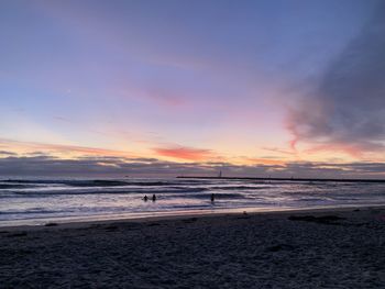 Scenic view of beach against sky during sunset