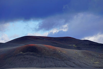 View of volcanic landscape against cloudy sky