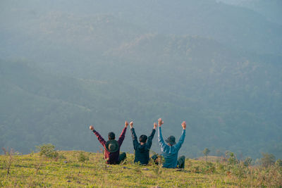 Group of hiker man relax with wellbeing and happy feeling on top of mountain