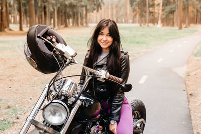 Portrait of smiling woman riding motorcycle