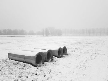 Snow covered land against sky