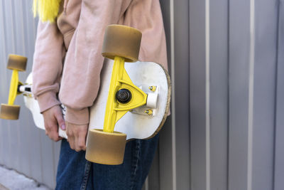 Midsection of woman working on wall at home