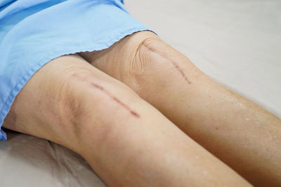 Close-up of woman hand on bed