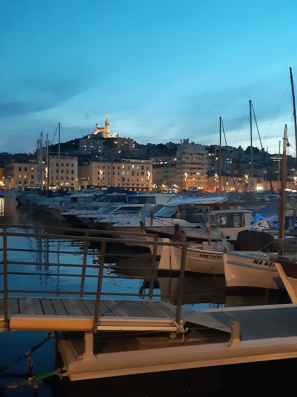 SAILBOATS MOORED IN HARBOR