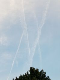 Low angle view of vapor trails in sky