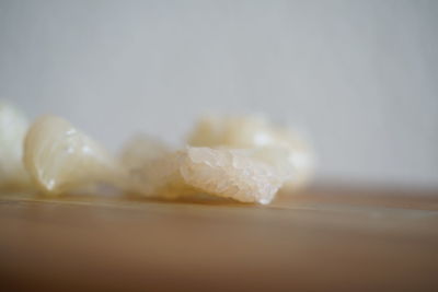 Close-up of ice cream on table against white background