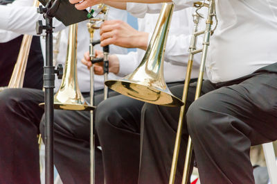 Midsection of people playing musical instruments