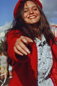 Portrait of smiling young woman standing outdoors