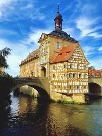 Arch bridge over river against buildings