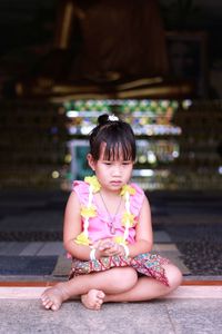 Portrait of a girl sitting outdoors