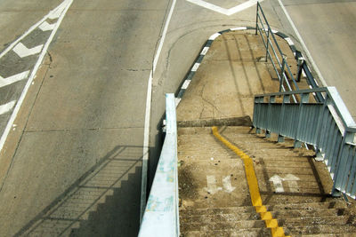 High angle view of stairs by empty road