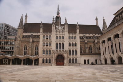 Facade of historic guildhall building against sky