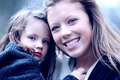 Close-up portrait of happy mother and baby